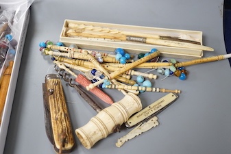 A collection of 19th century bone and ivory mounted penknives, bobbins etc